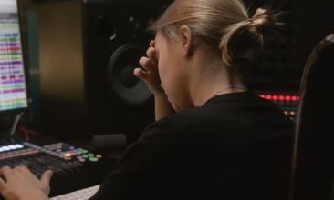 Producer reviewing audio feedback remotely on a laptop