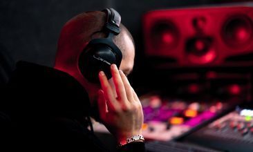 Music producer comparing two mix versions during A/B listening